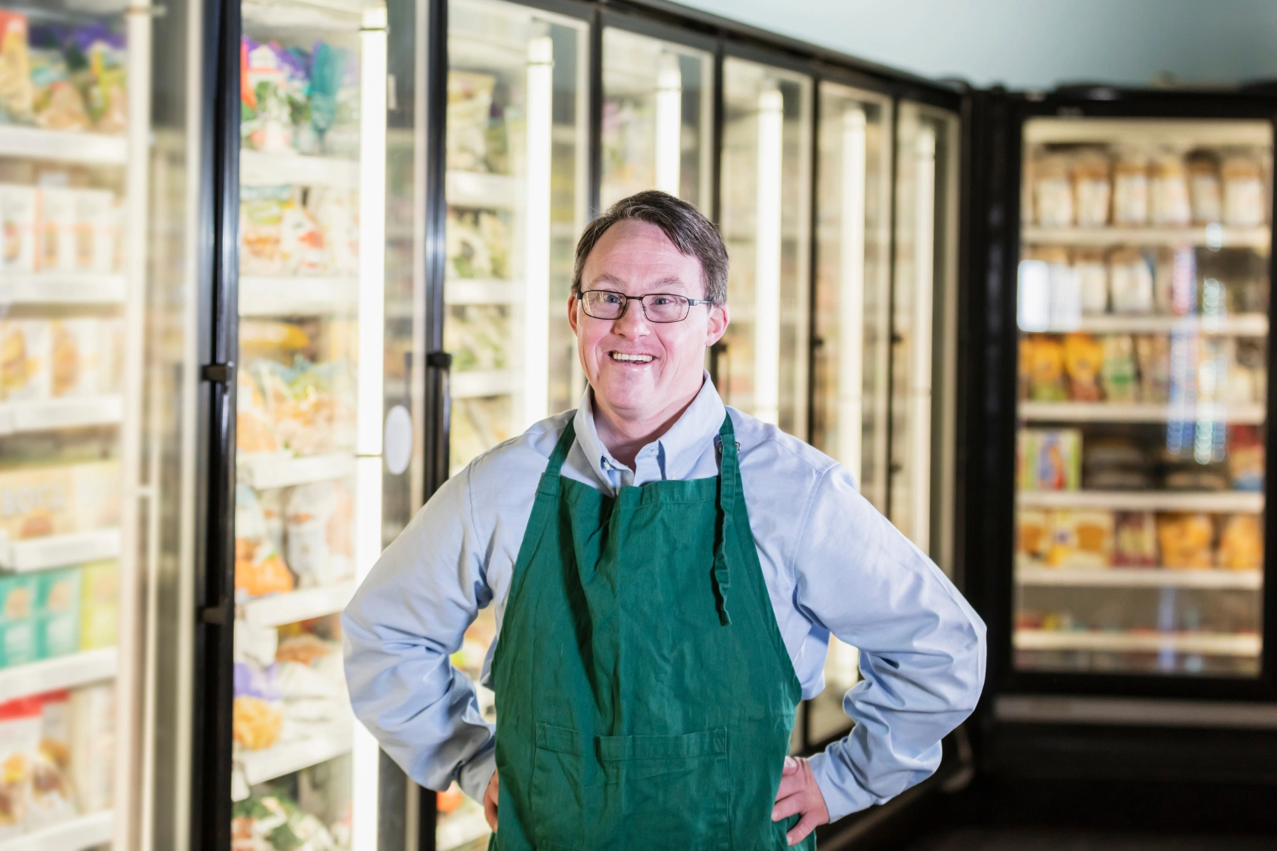 Man with down syndrome working in supermarket